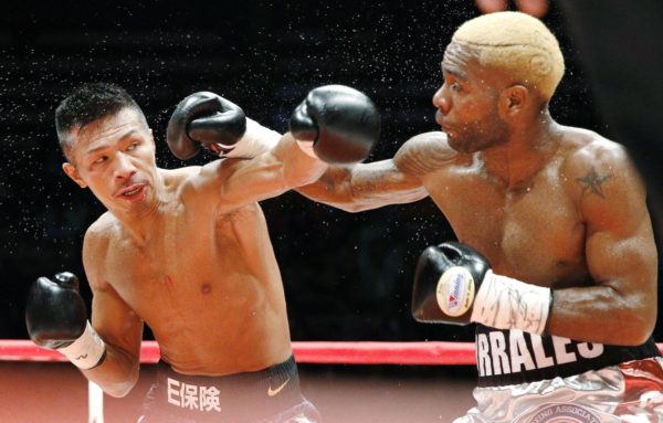 WBA super featherweight champion Jezreel Corrales (right) and Takashi Uchiyama exchange punches during Saturday night's title fight at Ota City General Gymnasium. Corrales recorded a split-decision win. | KYODO